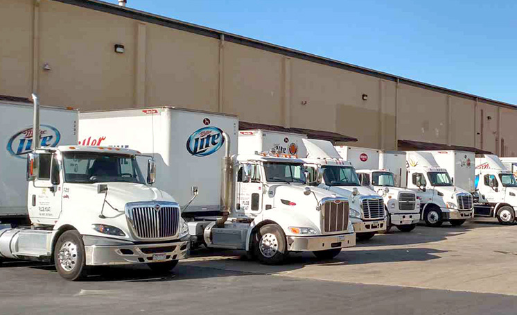 Miller Lite trucks in front of a warehouse