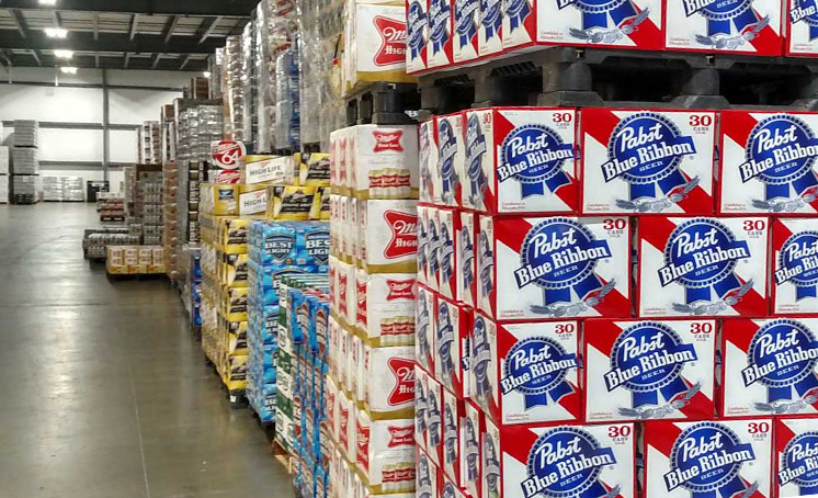 cases of beer on palettes in a warehouse