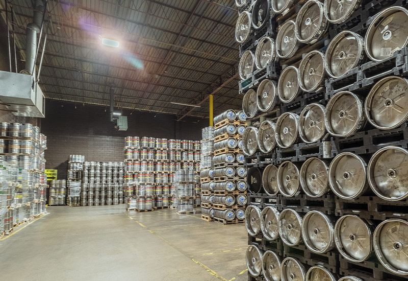 Pallets of kegs stacked in warehouse